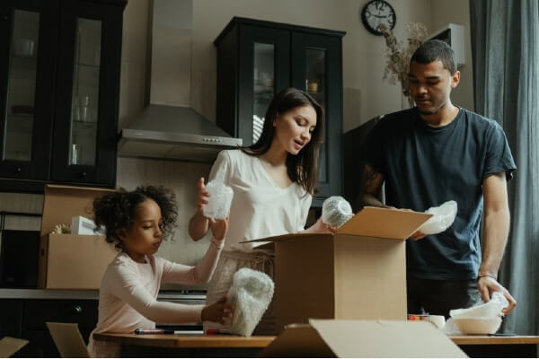 family packing up boxes for a move